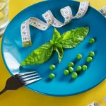 Diet blue plate with centimeter peas and basil